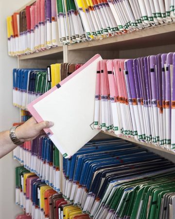 a-closeup-of-a-hand-removing-a-file-folder-from-a-2026-01-09-09-08-17-utc